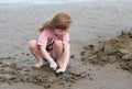 Young child playing, making sandcastles on a beach Royalty Free Stock Photo