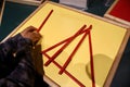 Young child playing with red long sticks, enjoying their time creating imaginative structures