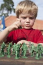 Young child playing soldiers Royalty Free Stock Photo