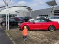 Young Child Points to Red Convertible Audi