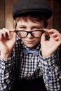 Young child, portrait and glasses with thinking in mockup, pensive and vintage fashion with eyesight. Boy, face or geek