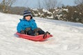 Young child on red sled Royalty Free Stock Photo