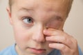 Young child rubbing his eyes with his fingers Royalty Free Stock Photo