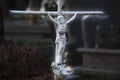 Young child`s grave. Crucifix on the cross made of an iron bar concept of death