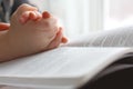 Young Child's Hands Praying on Holy Bible Royalty Free Stock Photo