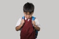 Young child in school uniform feeling sad and depressed looking down scared and embarrassed victim of bullying and abuse Royalty Free Stock Photo