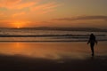 Young child silhouette on the beach in Exmouth Devon UK