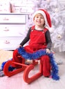 Young child sit indoor on sledge at christmas Royalty Free Stock Photo