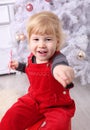 Young child sit indoor on sledge at christmas Royalty Free Stock Photo