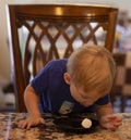 Young child sitting at a table waiting patiently for a marshmallow