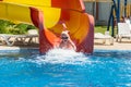 Young child sliding down a waterslide Royalty Free Stock Photo