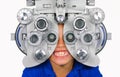 Young child smiling happy at hospital looking through optometric hospital device checking eyes having sight exam in ophthalmology Royalty Free Stock Photo