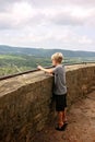 Young Child Standing on Tiptoes Looking over Scenic Overlook Cliff in Midwest America