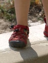 Young child walking towards the camera in modern red shoes Royalty Free Stock Photo