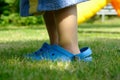 A young child is wearing too big shoes Royalty Free Stock Photo
