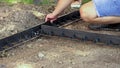 Young children constructing a path, laying delimiter panel