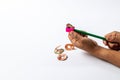 Young children hand using pink color pencil sharpener for pencil shaving his color pencil on white background. Royalty Free Stock Photo