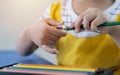 Young children hands using pencil sharpener for sharpening colored pencils. Education concept Royalty Free Stock Photo