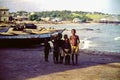 Young children near fishing boats on a beach near Accra, Ghana, c.1959