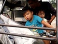 Young children rides a tricycle on the driver`s seat.