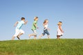 Young children running through field