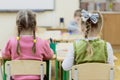 Young children sit in kindergarten at the table engaged, draw, learn in the nursery