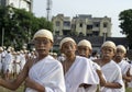 Young children standing in queue dressed up as Gandhi for world