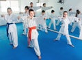 Children training karate kicks during karate class