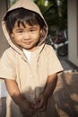 Young children wearing hood sweat with lovely face standing at h
