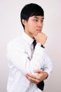Young Chinese business man thinking. Royalty Free Stock Photo