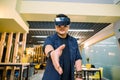 Young Chinese businessman working in office with virtual reality glasses on head. Man using VR headset for handshaking Royalty Free Stock Photo