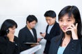 Young Chinese businesswoman talking on cell phone