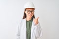 Young chinese engineer woman wearing coat helmet glasses over isolated white background doing happy thumbs up gesture with hand Royalty Free Stock Photo