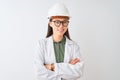 Young chinese engineer woman wearing coat helmet glasses over isolated white background happy face smiling with crossed arms Royalty Free Stock Photo