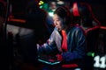 A young chinese esports player at an international esports tournament. A multi-racial cyber team is playing an online