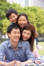 Young Chinese Family Relaxing In Park Together Royalty Free Stock Photo