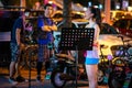 Young Chinese girl playing acoustic guitar and singing in the street in Beijing Royalty Free Stock Photo