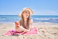 Young chinese girl wearing bikini using smartphone at the beach Royalty Free Stock Photo