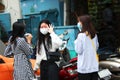 Young Chinese girls are standing on the street in gauze masks on their faces. The threat of a coronavirus epidemic in China. Copy