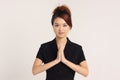 Young Chinese lady in formal attire with Namaste pose