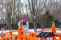 Young Chinese lady standing on traditional red bridge Royalty Free Stock Photo