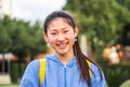 Young chinese lady student smiling looking at camera at the high school. Close up portrait of cute asian girl standing Royalty Free Stock Photo