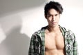Young chinese male model baring chest, attitude