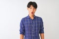 Young chinese man wearing casual blue shirt standing over isolated white background afraid and shocked with surprise expression, Royalty Free Stock Photo