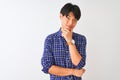Young chinese man wearing casual blue shirt standing over isolated white background looking confident at the camera smiling with Royalty Free Stock Photo