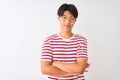 Young chinese man wearing glasses and striped t-shirt standing over isolated white background happy face smiling with crossed arms Royalty Free Stock Photo