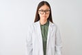 Young chinese scientist woman wearing coat and glasses over isolated white background with serious expression on face Royalty Free Stock Photo