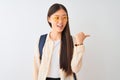 Young chinese student woman wearing glasses and backpack over isolated white background smiling with happy face looking and Royalty Free Stock Photo
