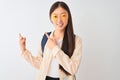 Young chinese student woman wearing glasses and backpack over isolated white background smiling and looking at the camera pointing Royalty Free Stock Photo