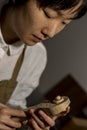 Young Chinese violin maker at work in her workshop Royalty Free Stock Photo